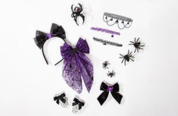 Assorted Halloween accessories in black and purple, including bows, spider clips, chokers, and a mask.
